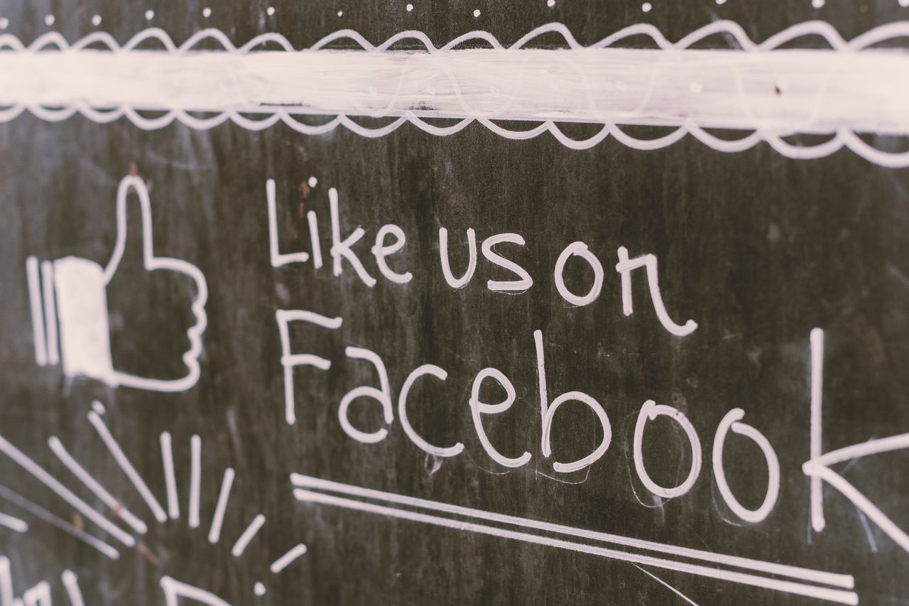 hero-img-01 Chalkboard art promoting Facebook engagement with a like us message.
