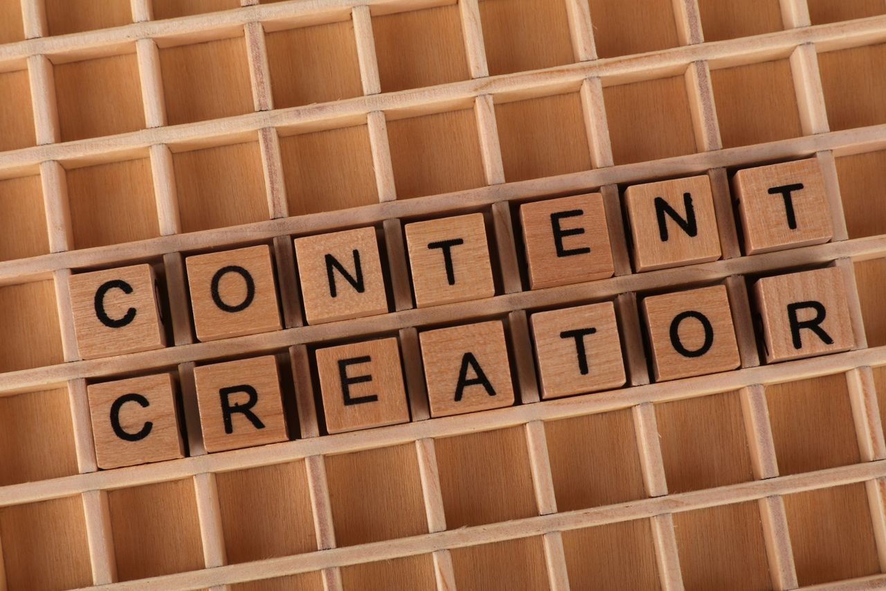 gallery-2 Wooden letter blocks arranged to spell 'Content Creator' symbolizing creativity and digital media.