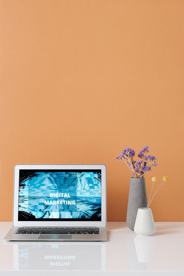hero-img-02 Modern workspace with laptop and decorative flowers showcasing digital marketing.