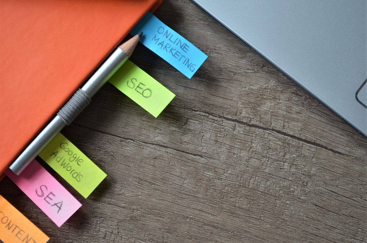 about-01 Close-up of SEO strategy planner with colorful sticky notes and a pencil on a notebook.